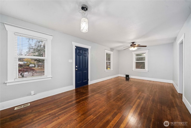 entryway with a healthy amount of sunlight, baseboards, visible vents, and hardwood / wood-style floors