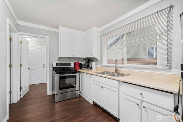 kitchen with a sink, white cabinets, light countertops, dark wood finished floors, and stainless steel range with electric stovetop