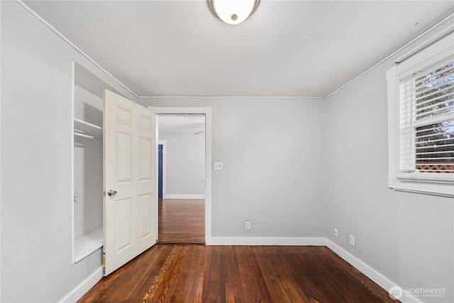 unfurnished bedroom with wood-type flooring and baseboards