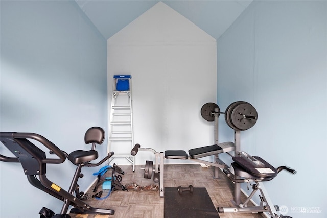 workout area featuring high vaulted ceiling and baseboards