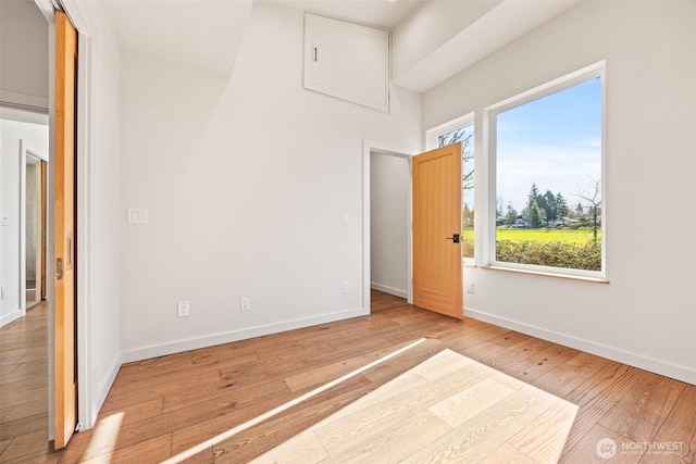 unfurnished bedroom with wood-type flooring and baseboards