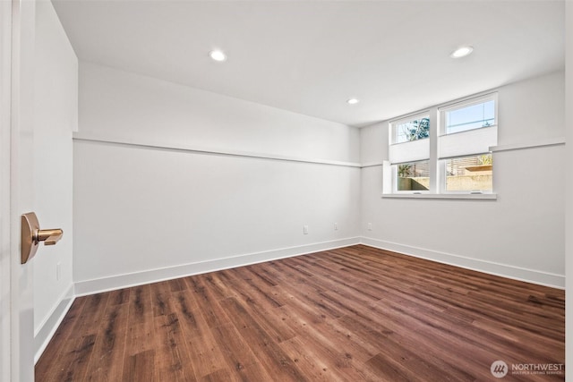 spare room featuring recessed lighting, wood finished floors, and baseboards