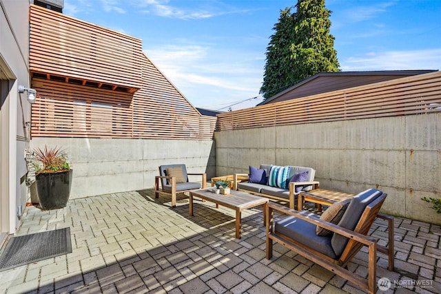 view of patio / terrace with fence and an outdoor living space