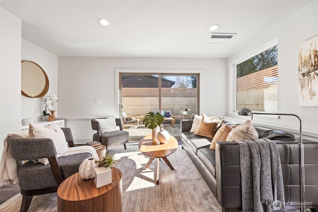 living room with wood finished floors, visible vents, and recessed lighting