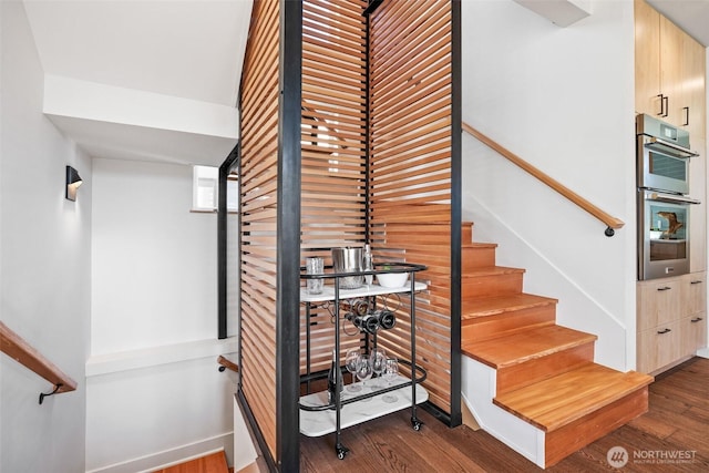 staircase with wood finished floors