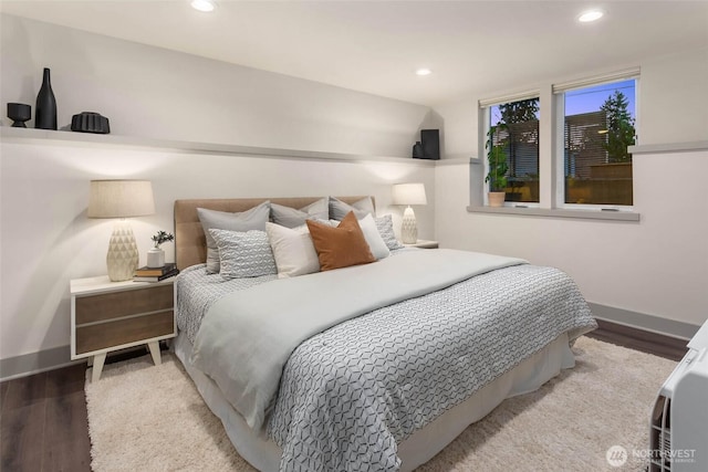 bedroom featuring baseboards, wood finished floors, and recessed lighting