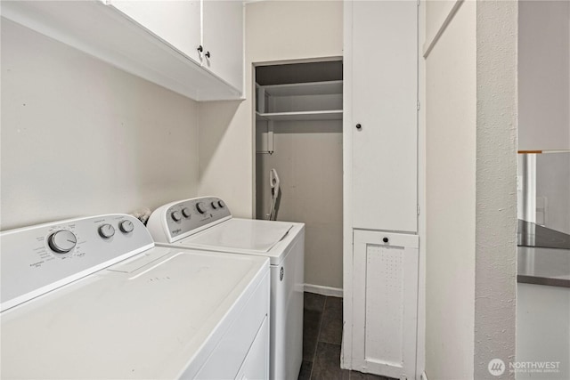 clothes washing area with independent washer and dryer and cabinet space