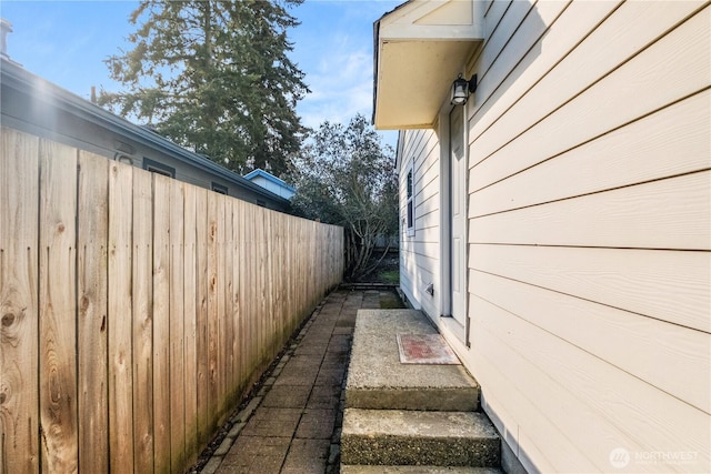 view of side of property featuring fence