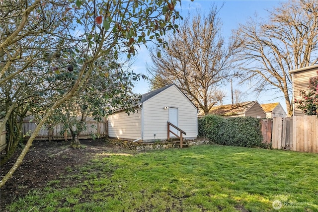 view of yard featuring an outdoor structure and a fenced backyard