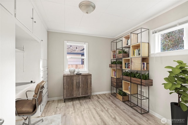 office area featuring baseboards, ornamental molding, and light wood-style floors