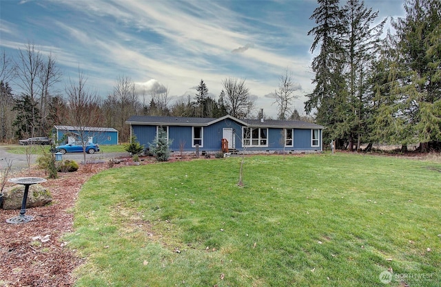 back of house with crawl space and a yard