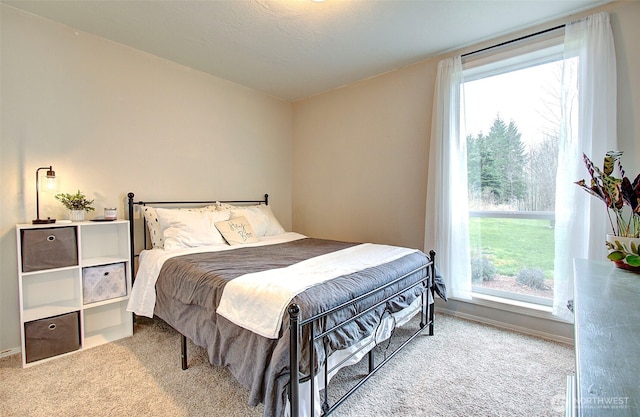 bedroom featuring carpet and baseboards