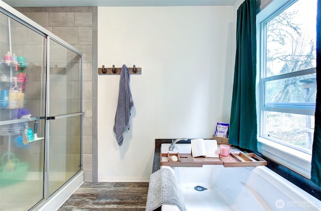 full bathroom with a stall shower and wood finished floors