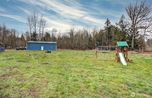 view of yard featuring a playground and an outdoor structure