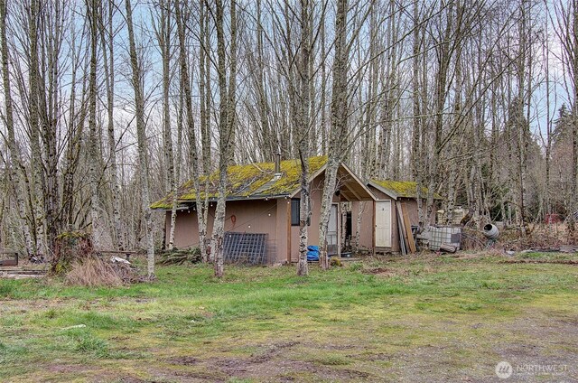 exterior space featuring a forest view