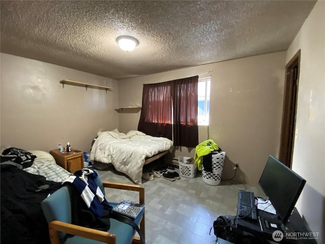 bedroom featuring a textured ceiling and tile patterned floors