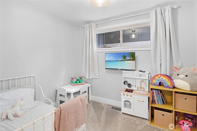 carpeted bedroom featuring baseboards