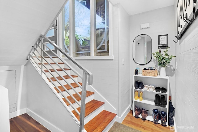 stairs featuring wood finished floors and baseboards