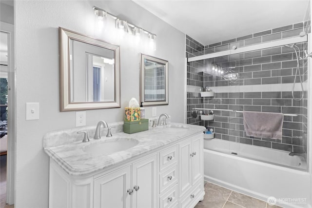 full bathroom with double vanity, tile patterned flooring, a sink, and bathing tub / shower combination