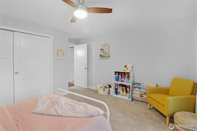 bedroom featuring baseboards, carpet, a ceiling fan, and a closet