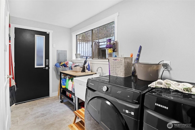 washroom with laundry area, independent washer and dryer, and baseboards