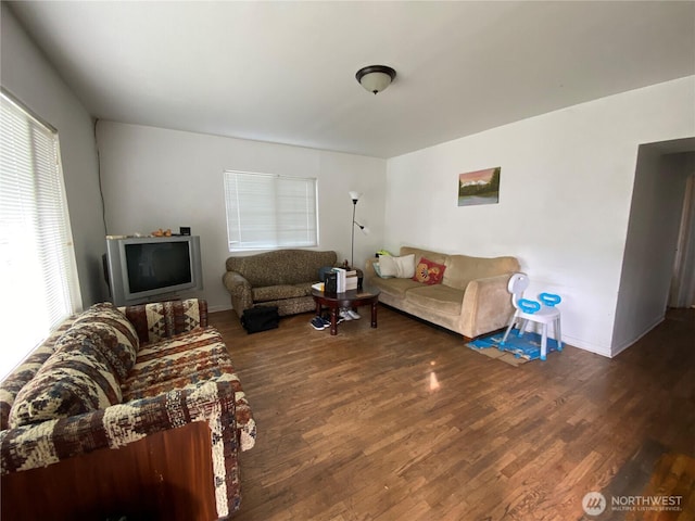 living area with wood finished floors and baseboards