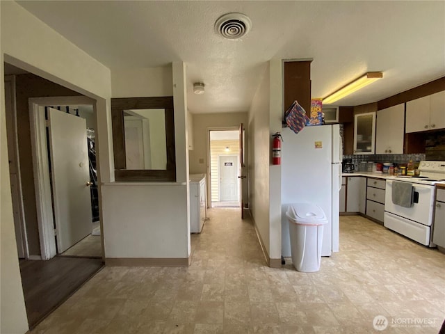 kitchen with white appliances, visible vents, baseboards, light countertops, and tasteful backsplash