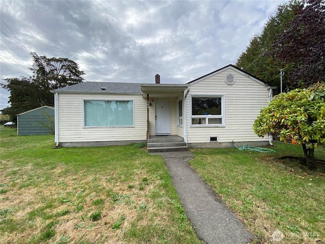 view of front of home with a chimney and a front yard