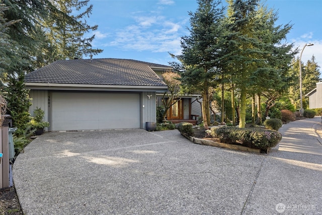 view of front of house with driveway and a tiled roof