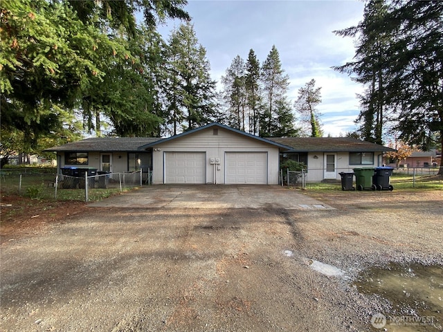 single story home featuring fence, driveway, and an attached garage