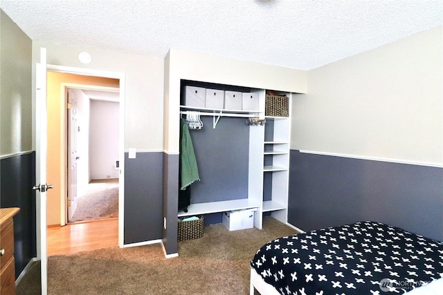 carpeted bedroom with a textured ceiling