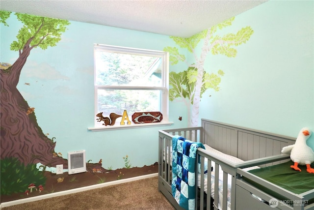 bedroom featuring a nursery area, visible vents, carpet flooring, and a textured ceiling