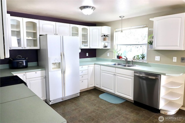 kitchen with a sink, white fridge with ice dispenser, white cabinetry, open shelves, and stainless steel dishwasher