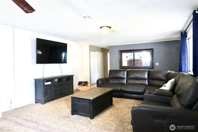 living area featuring light carpet and a textured ceiling