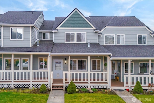 view of front of property featuring a porch, a front yard, and roof with shingles