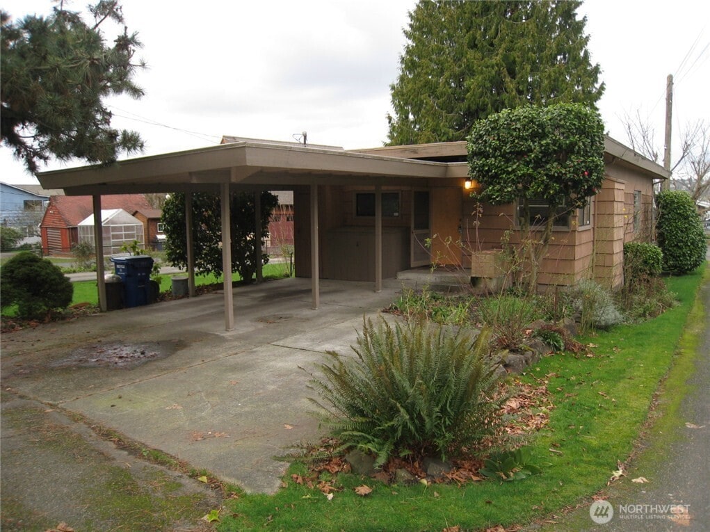 single story home with a carport and concrete driveway