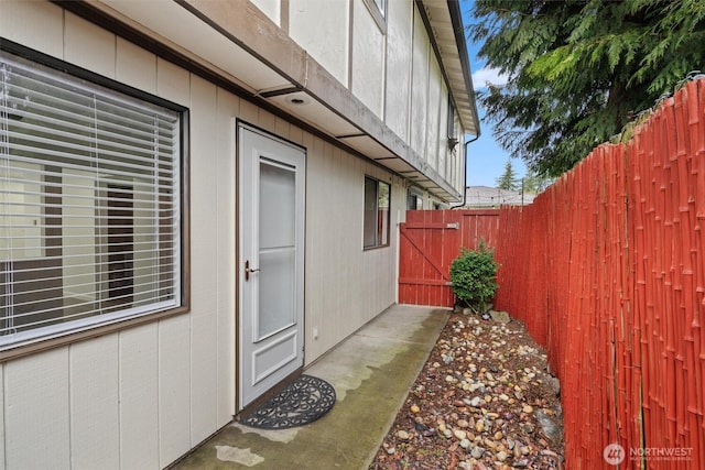 view of home's exterior with fence and a gate