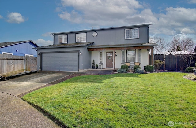 traditional-style home with a front yard, fence, driveway, covered porch, and a garage