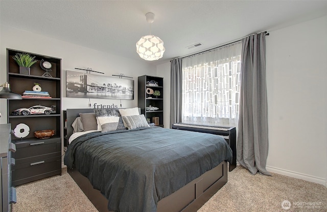 carpeted bedroom with visible vents and baseboards