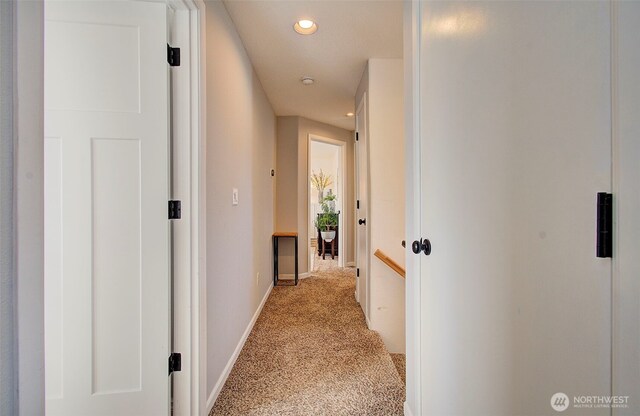 hallway with recessed lighting, baseboards, and light carpet