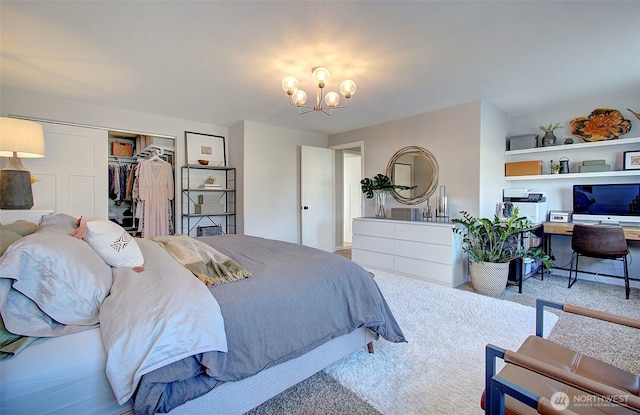 bedroom with a closet, carpet floors, and a chandelier