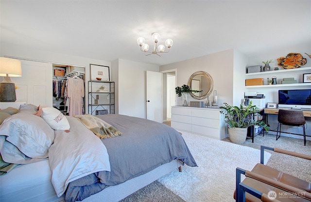 bedroom featuring a closet, carpet floors, and a chandelier