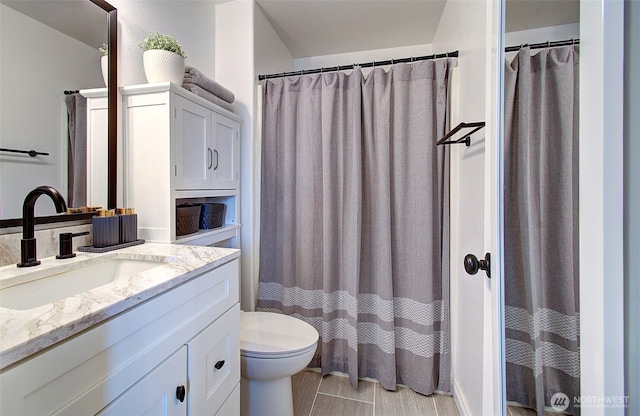 bathroom featuring toilet and vanity