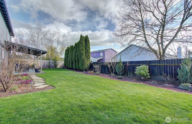 view of yard featuring a patio area and a fenced backyard