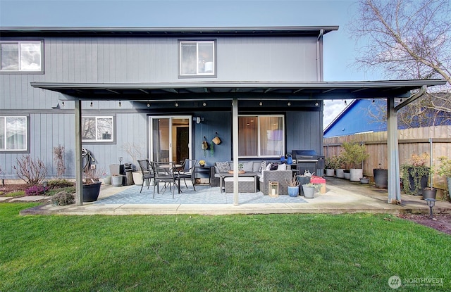 back of property featuring a patio area, a yard, outdoor lounge area, and fence