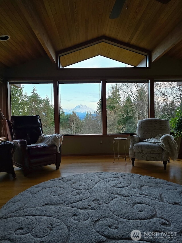 sunroom / solarium with vaulted ceiling with beams, wood ceiling, and a mountain view