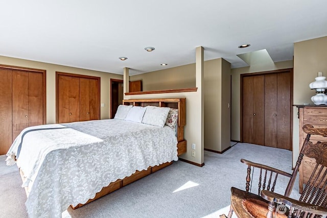 carpeted bedroom with baseboards, recessed lighting, and multiple closets