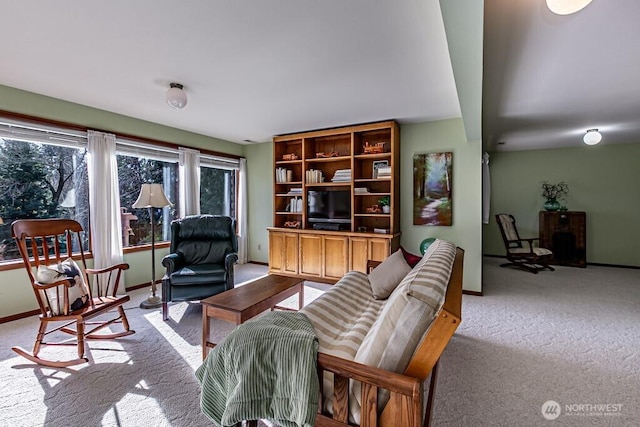 living room featuring light colored carpet and baseboards