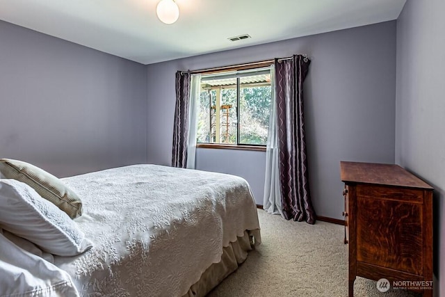 carpeted bedroom with baseboards and visible vents