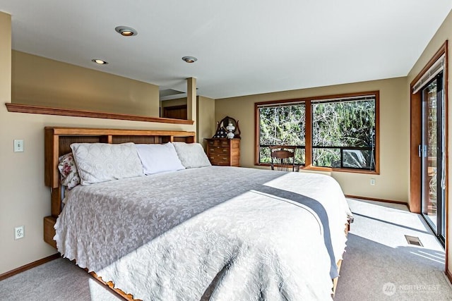 bedroom featuring carpet, multiple windows, visible vents, and baseboards